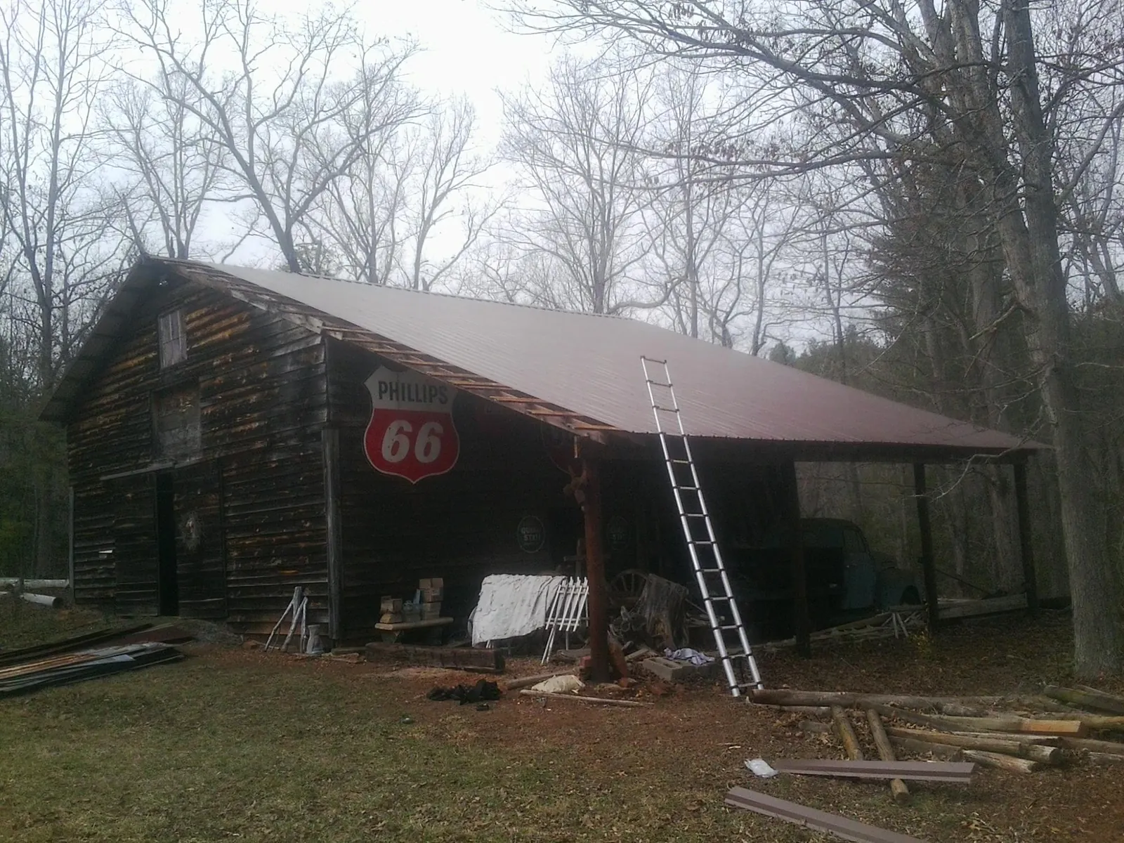 New metal roof on an open sided timber barn with a vintage sign in Jamestown